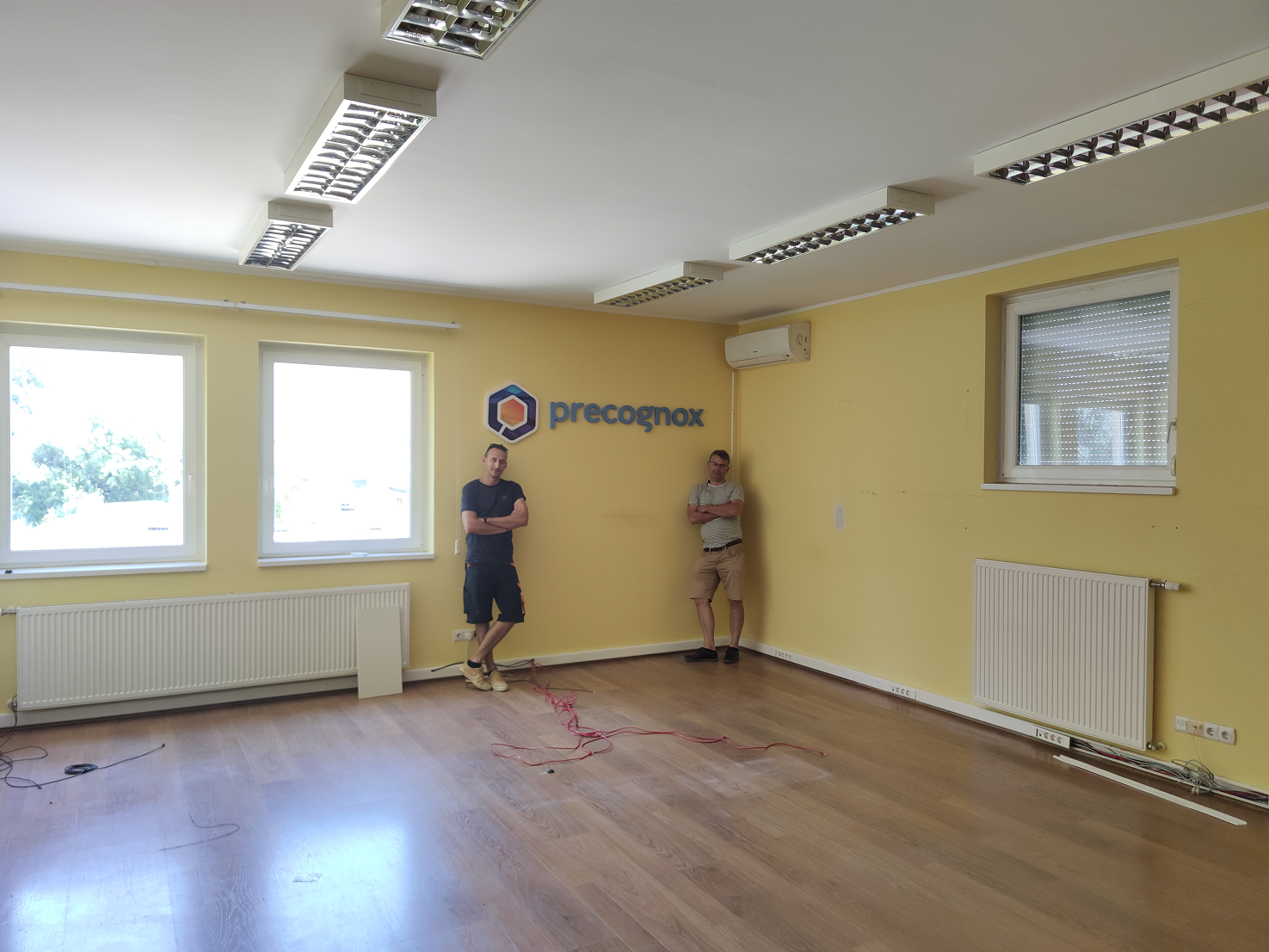 Endre and Ricsi standing in Precognox’s old office during the move.
